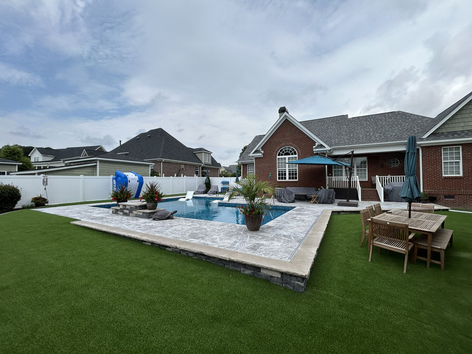 Elevated Backyard Retreat with Custom Water Feature & Luxury Marble Deck