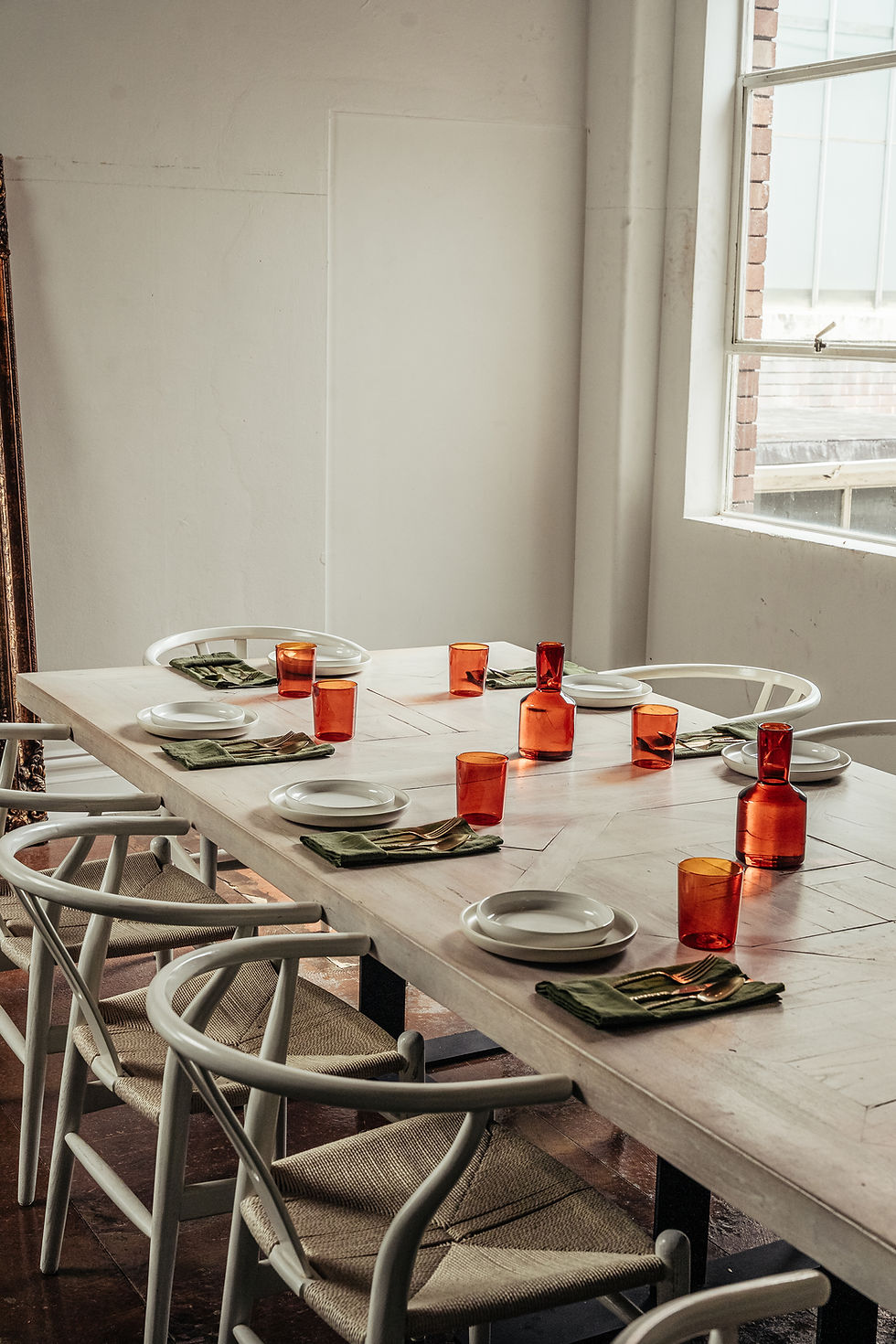 beautifully set table with orange glasses