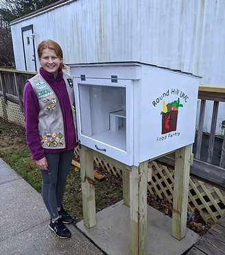 Girl Scout in front of Blessings Box