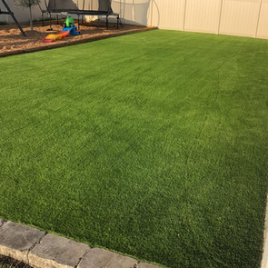 DelaTurf artificial grass installation in an Orlando backyard with no sprinklers running