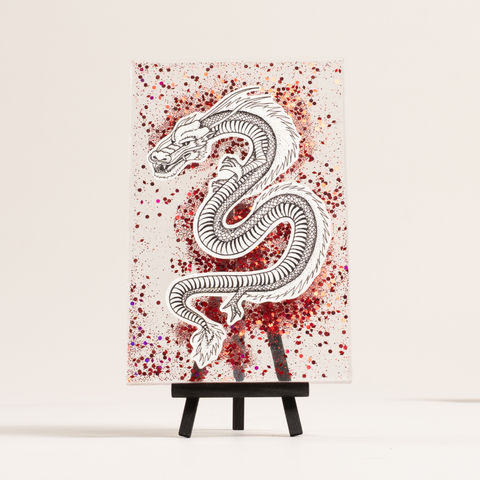 Powerful dragon floating over translucent and red sparkle resin