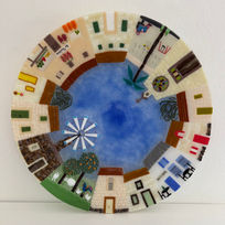 This piece is made from thousands of small pieces of glass, each part of the circle depicting different parts of a village.