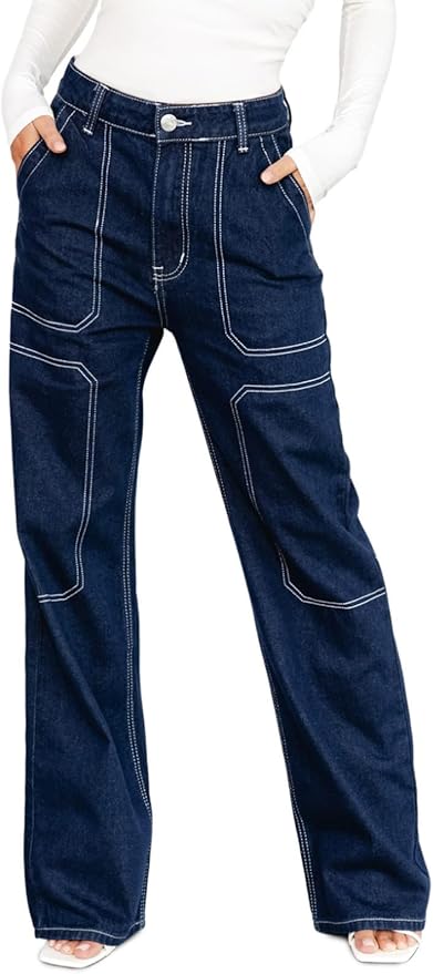 A woman stands wearing a pair of wide-leg dark denim jeans with detailed stitching, paired with a fitted white top.