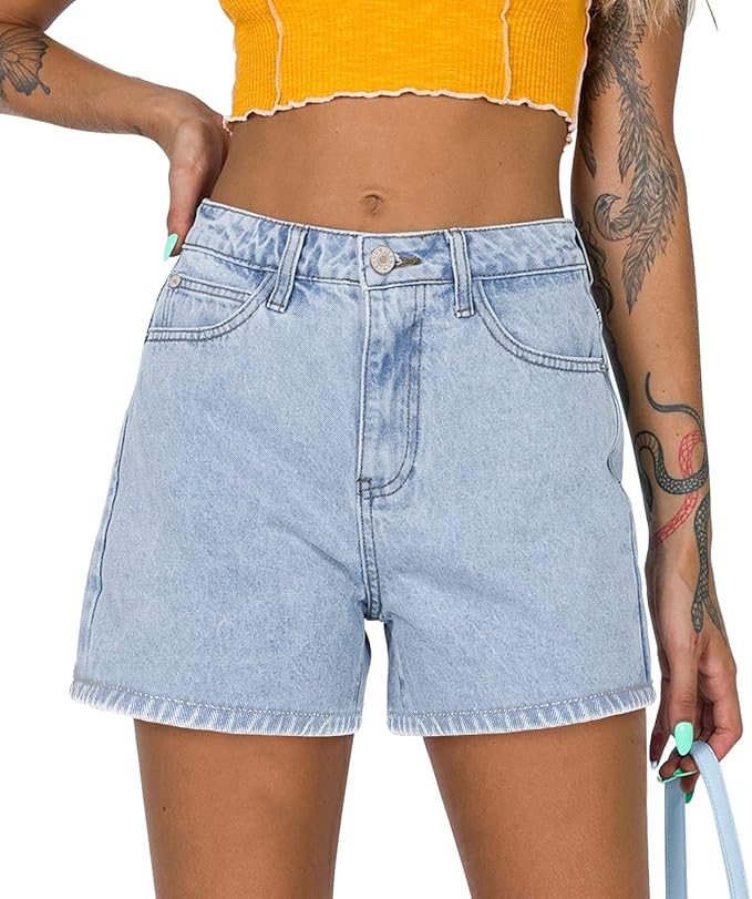 A person wearing a yellow cropped top paired with light blue denim shorts, showcasing a casual summer outfit.
