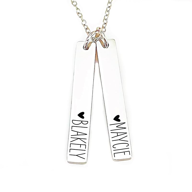 Close-up of a personalized silver jewelry necklace with engraved names 'Blakely' and 'Maycie', hanging on a chain.