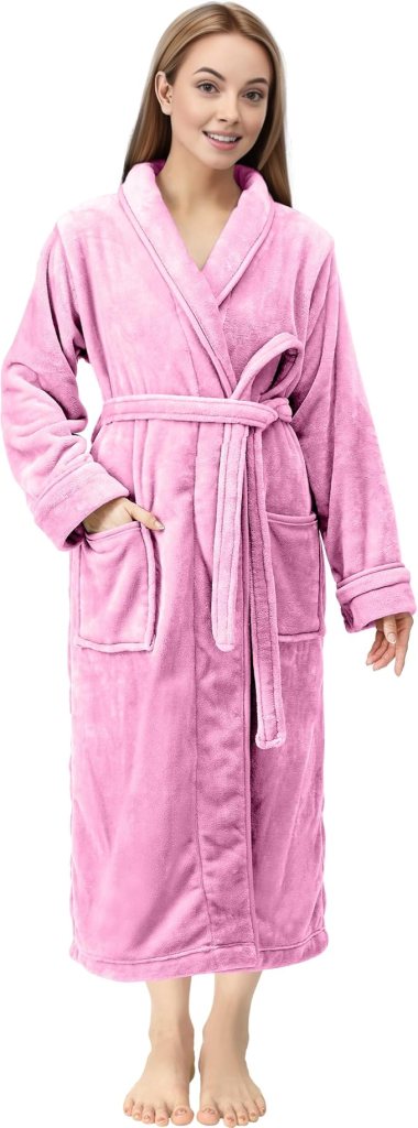 A woman standing in a fluffy pink robe, showcasing a cozy and stylish home attire option.