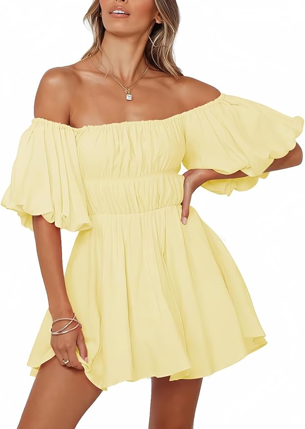 A woman wearing a yellow off-shoulder dress with puff sleeves, standing outdoors and posing confidently.