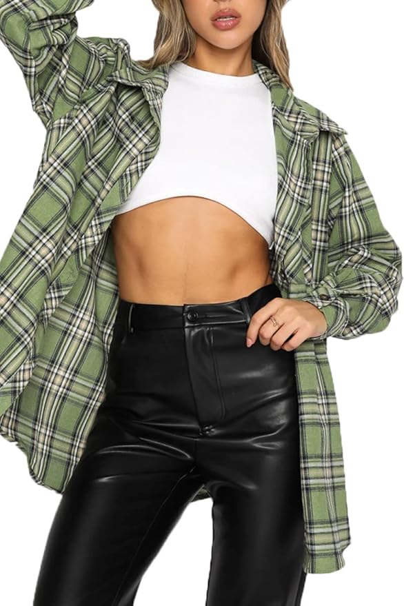 A person wearing a cropped white top and an oversized green plaid button-down shirt, paired with high-waisted black pants.