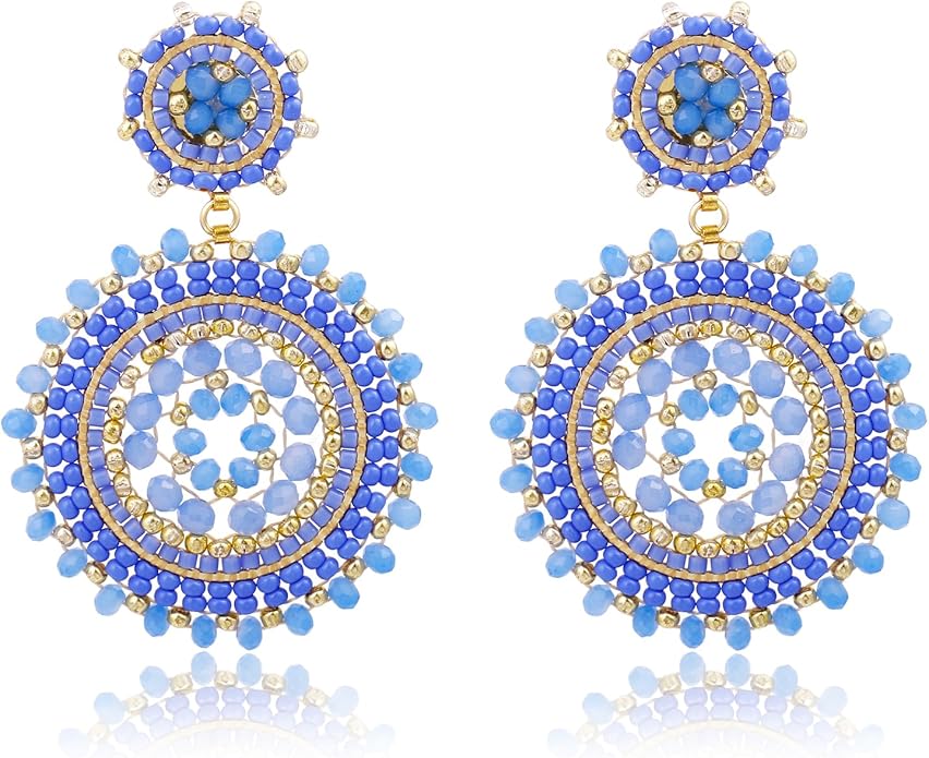 A pair of statement earrings featuring intricate circular designs in blue and gold tones.
