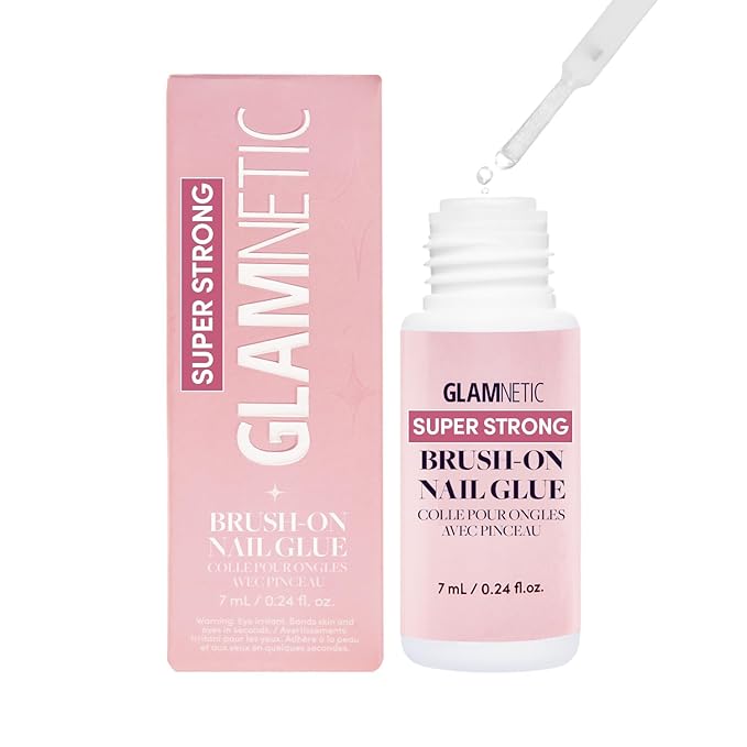A bottle of Glamnetic super strong brush-on nail glue with its packaging, featuring a pink design and a brush applicator for easy use.