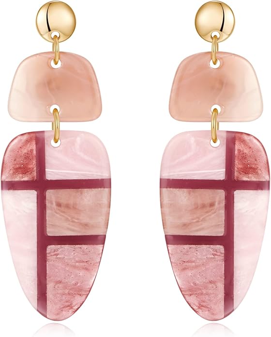 A pair of pink and cream statement earrings featuring geometric shapes, including a stud top and a dangling design with a mix of translucent and solid sections.