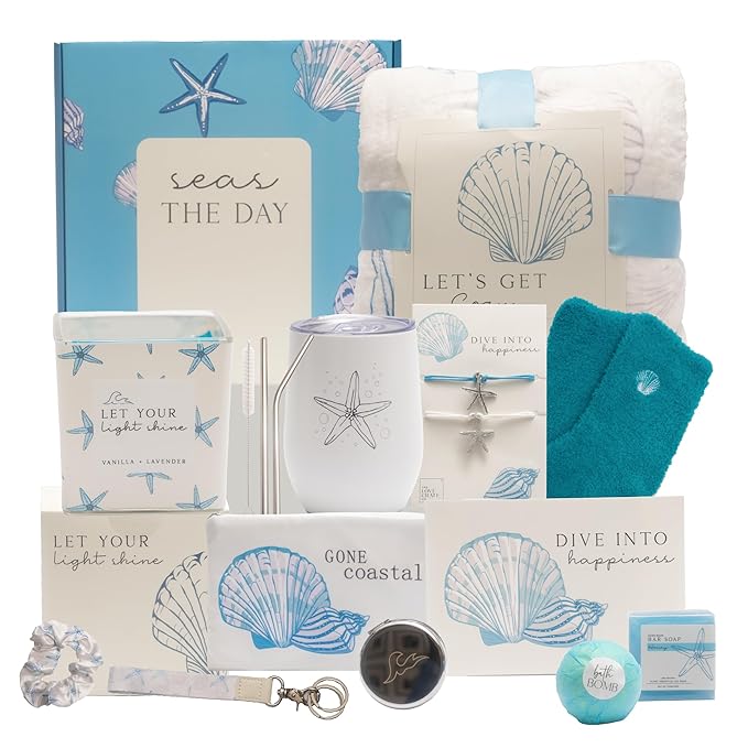 A curated gift basket featuring various self-care items, including a candle, blanket, and bath products, all themed with coastal designs and soothing colors.