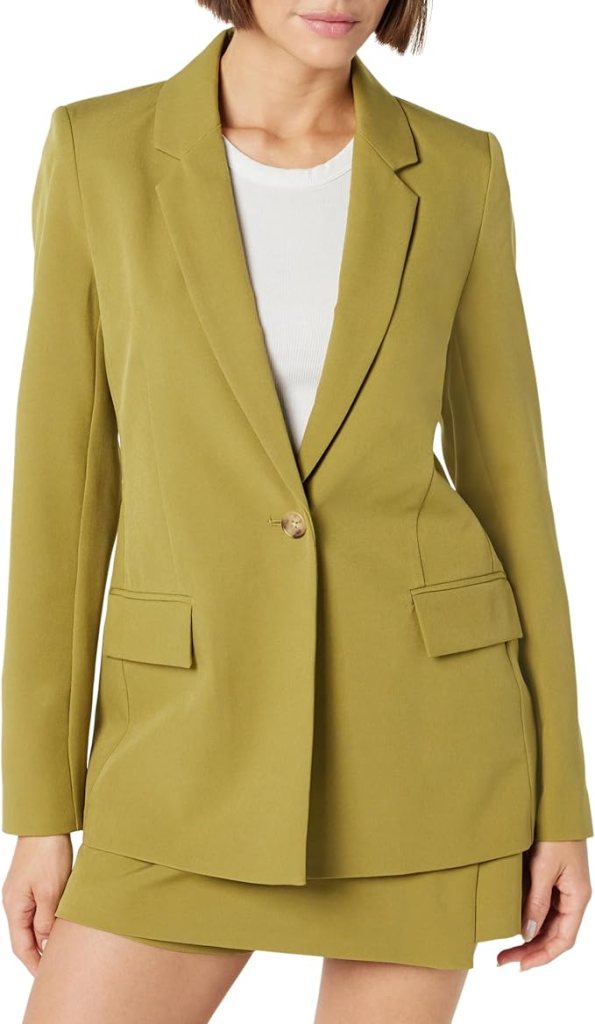 A model wearing a tailored olive green blazer over a white top, showcasing a stylish and polished look.