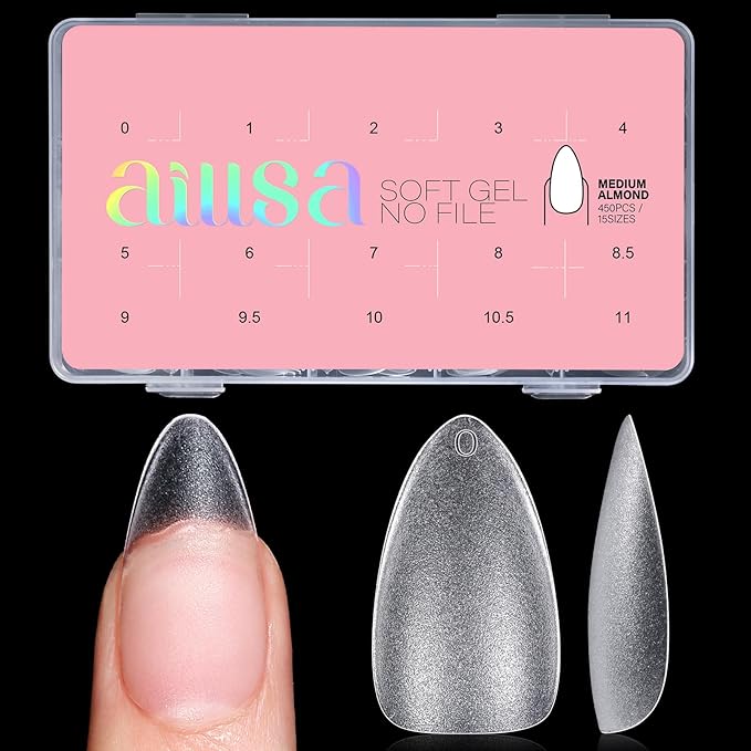 A close-up of a hand holding a soft gel nail tip against a pink background, with a transparent container displaying different nail sizes labeled for easy selection.
