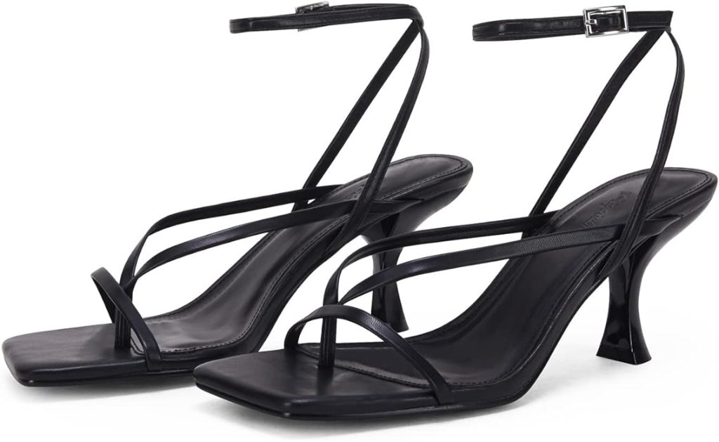 A pair of stylish black strappy sandals with a sleek design and a modest heel, perfect for summer outfits.