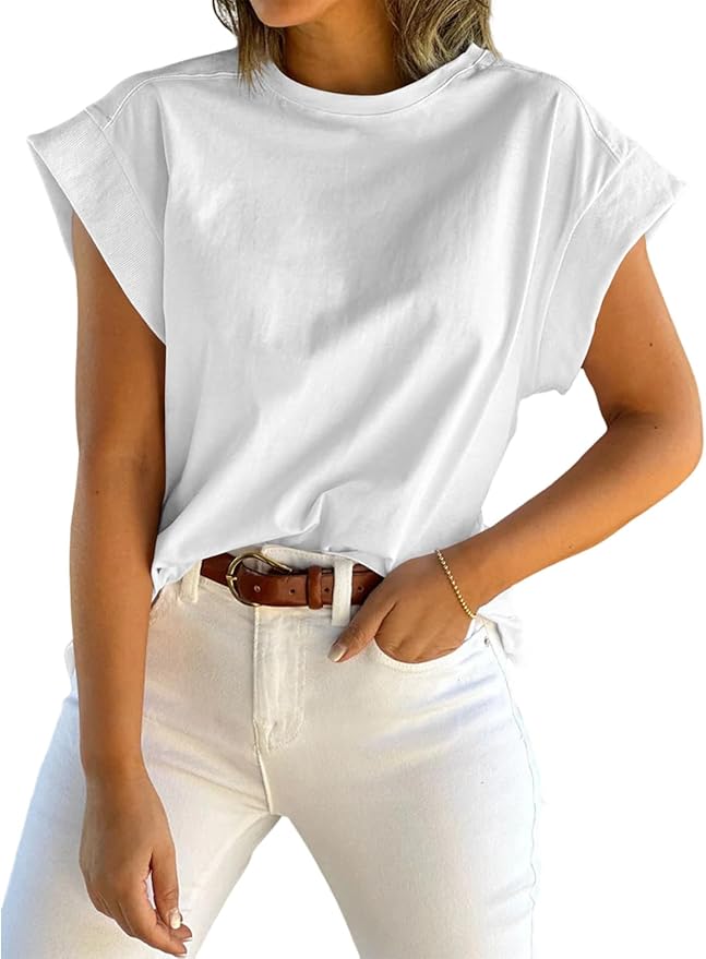 A woman wearing a white oversized t-shirt with rolled sleeves, paired with light-colored jeans and a brown belt.