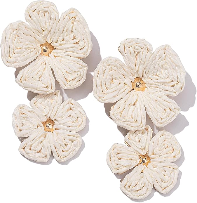Three decorative white flowers made from twisted material, featuring varying sizes and a central brown detail.