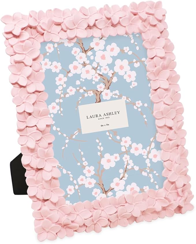 A decorative pink picture frame designed with flower-like embellishments, suitable for holding a 5x7 photo.