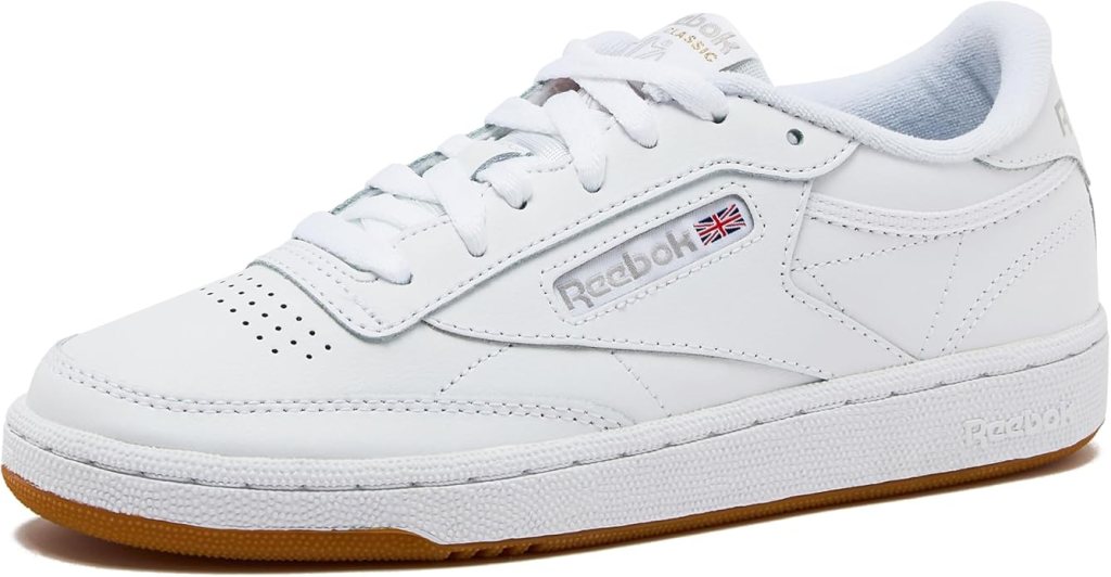 A stylish pair of white sneakers, featuring a classic design with a rubber sole and subtle branding, ideal for casual wear.