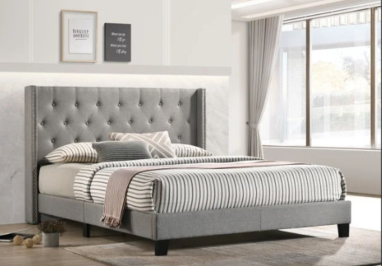 Grey upholstered bed with tall headboard