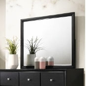 Black framed mirror on dresser