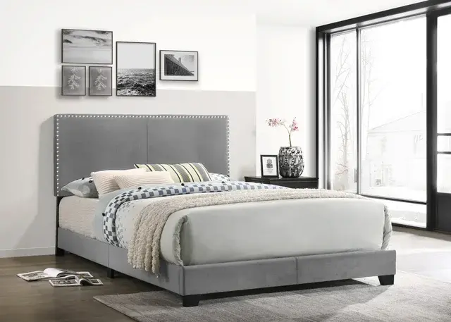 Grey upholstered bed in modern bedroom
