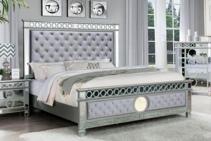 Grey upholstered bed with mirrored accents