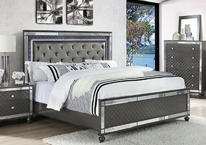 Grey upholstered bed with mirrored accents