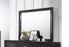 Black framed mirror on dresser with decor