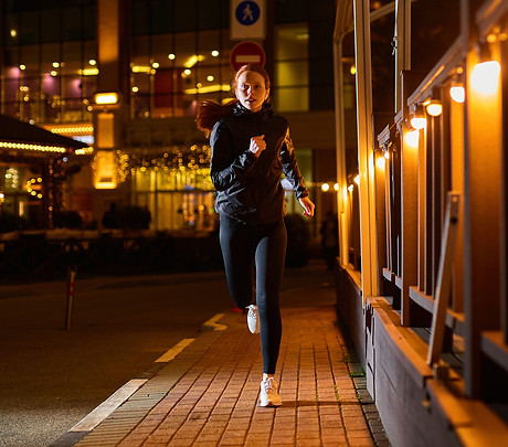 Woman-Jogging-in-Night-City-Street_AdobeStock.jpeg