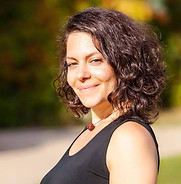 Kyneret, private yoga instructor, smiling outdoors. Contact page photo for Yoga With Kyneret.