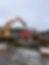 Excavators moving 40 foot seacan at a farm