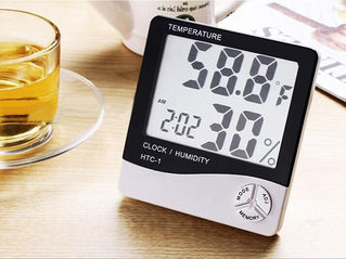 A temperature and a humidity meter sitting on a desk.