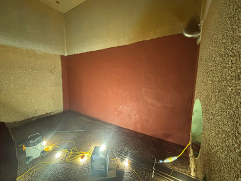 Room with new red wall paint and construction lights