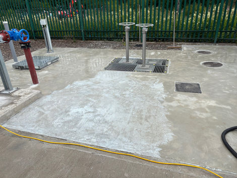 Concrete ground with white marks and two metal posts