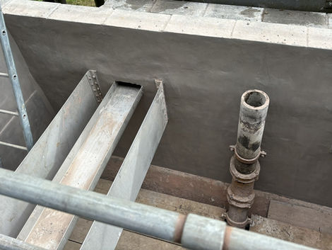 Water treatment tank interior with channels and pipe