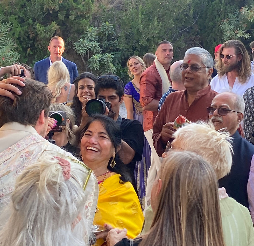 Family and wedding guests surrounding the couple during the Indian garland ceremony at El Molino de Casanova in Nerja