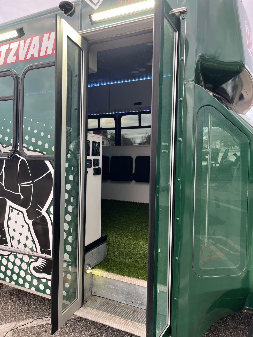 Mitzvah Tank 4 entryway with custom sports graphics and stadium-inspired interior for a high-energy tailgating experience.