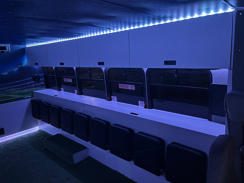 Mitzvah Tank 4 interior with LED-lit stadium murals, pop-down seating, and a tailgating-ready lounge setup.