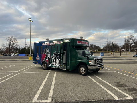 Mitzvah Tank 4, a fully custom tailgating bus with a stadium-inspired design, LED lighting, and game-day features.