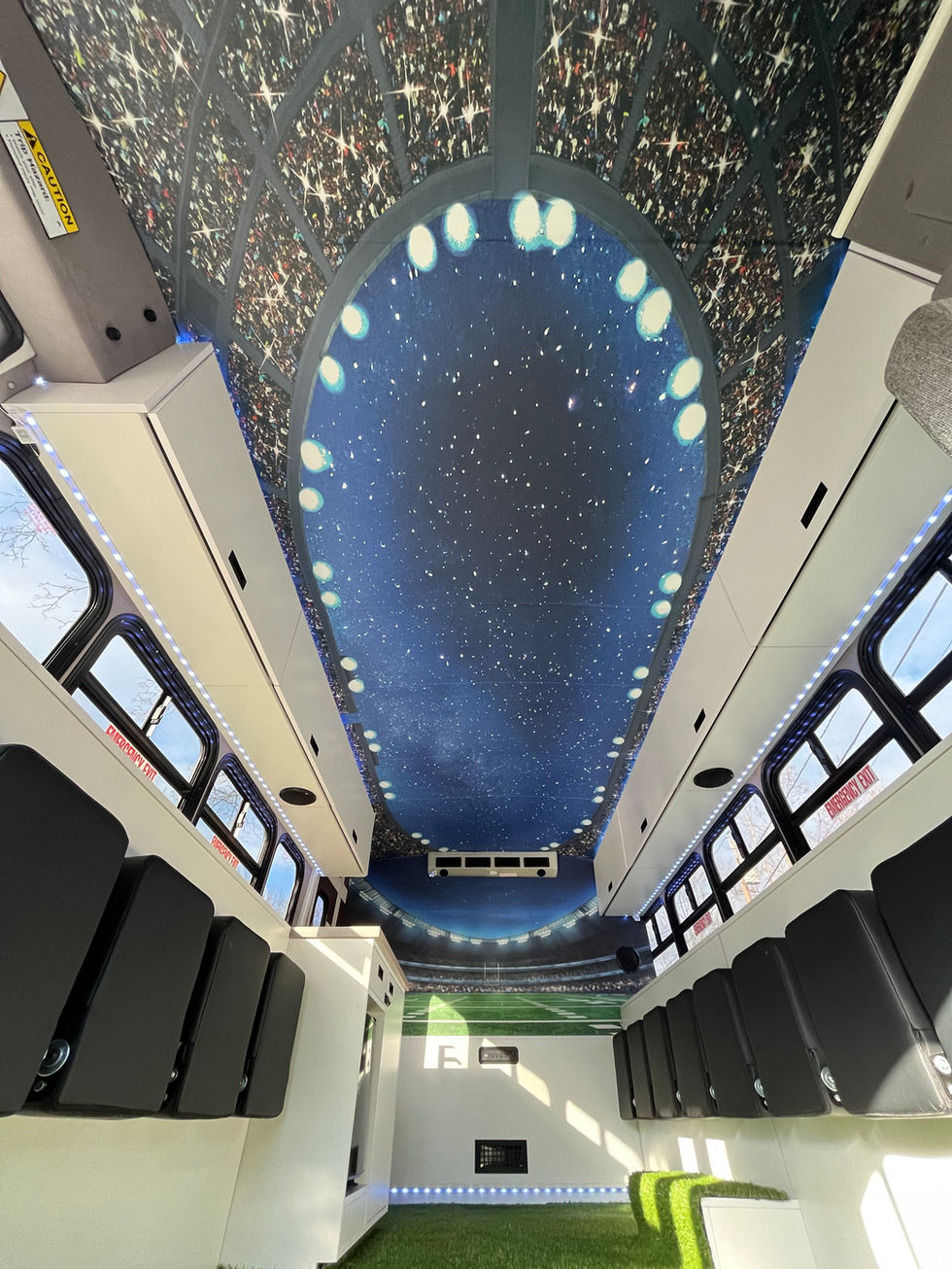 Mitzvah Tank 4 custom ceiling mural with stadium lights effect, integrated with LED accent lighting for a fully immersive experience.