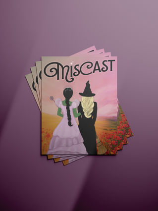 A woman with black hair in a lavender dress arm in arm with a blonde woman in a black dress and hat looking out at a field of flowers. The art nouveau style text above them says "Miscast". 