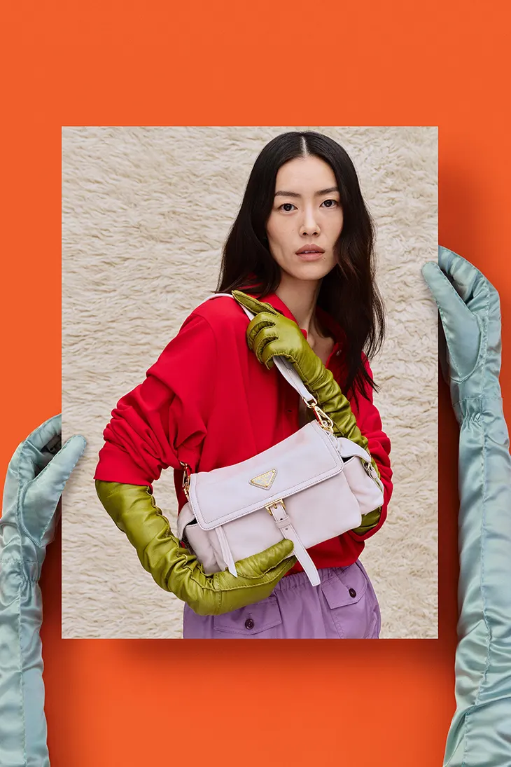 Liu Wen wearing lime green gloves, carrying a pink bag, wearing head to toe Prada.