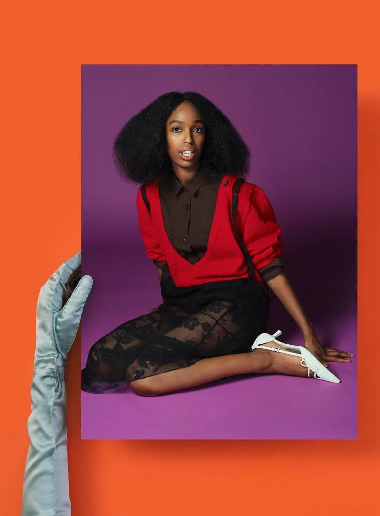 Model sitting on the floor, wearing Prada head to toe