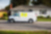 An unbranded home service van parked in front of a house for repairs or handyman work_edit