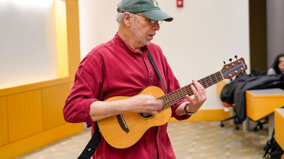 Barry Brown plays his guitar while sharing how music supported his cancer recovery
