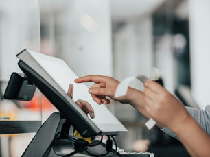 Laundromat owner comparing laundry POS software options