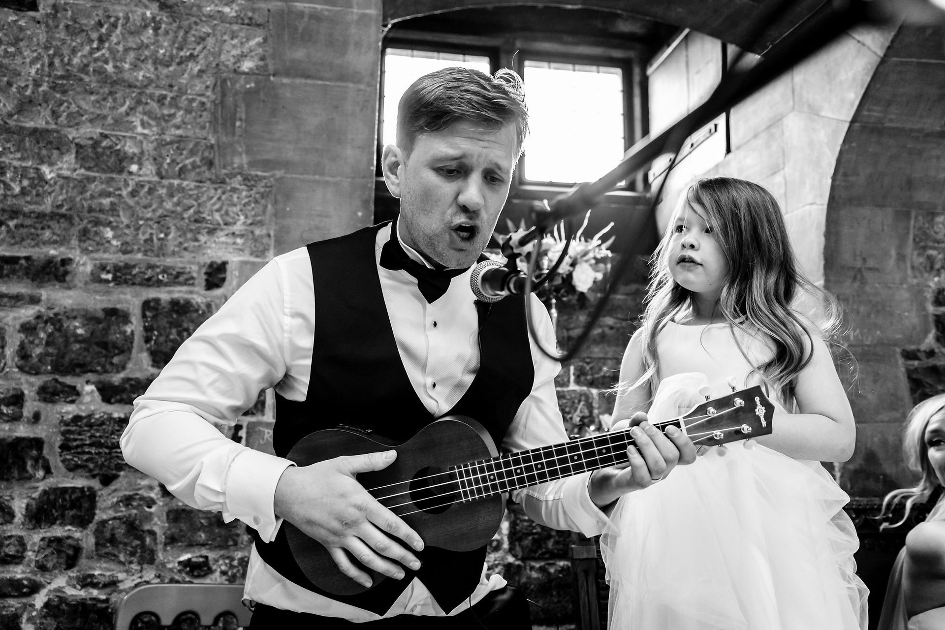 groom playing ukelele at cardiff castle wedding