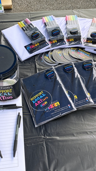 A variety of merchandise with the message "Support Local Artists"
