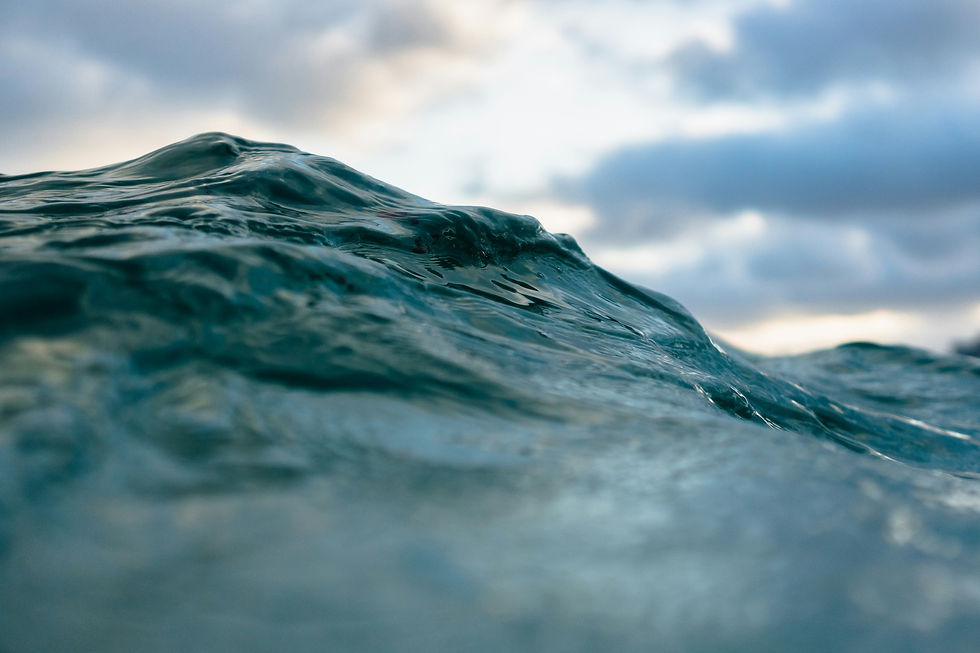 Close-up of a dark ocean wave cresting under a cloudy sky representing anxiety overwhelm failed executive composure